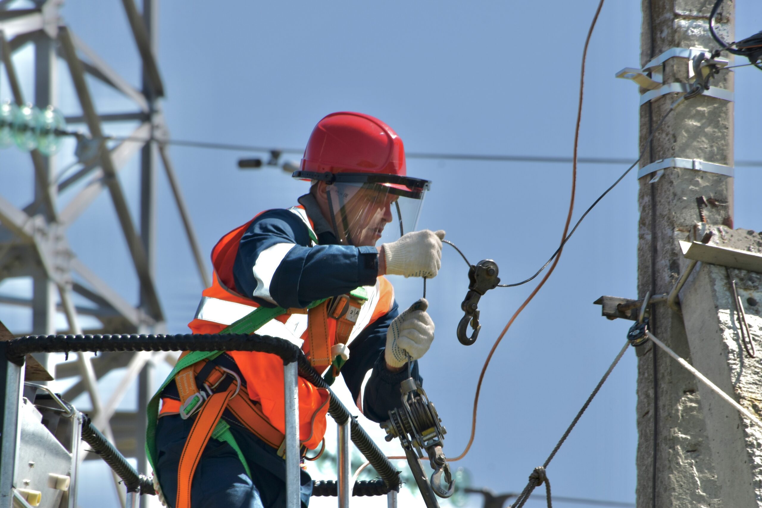 A climber inspecting a jammed belay device