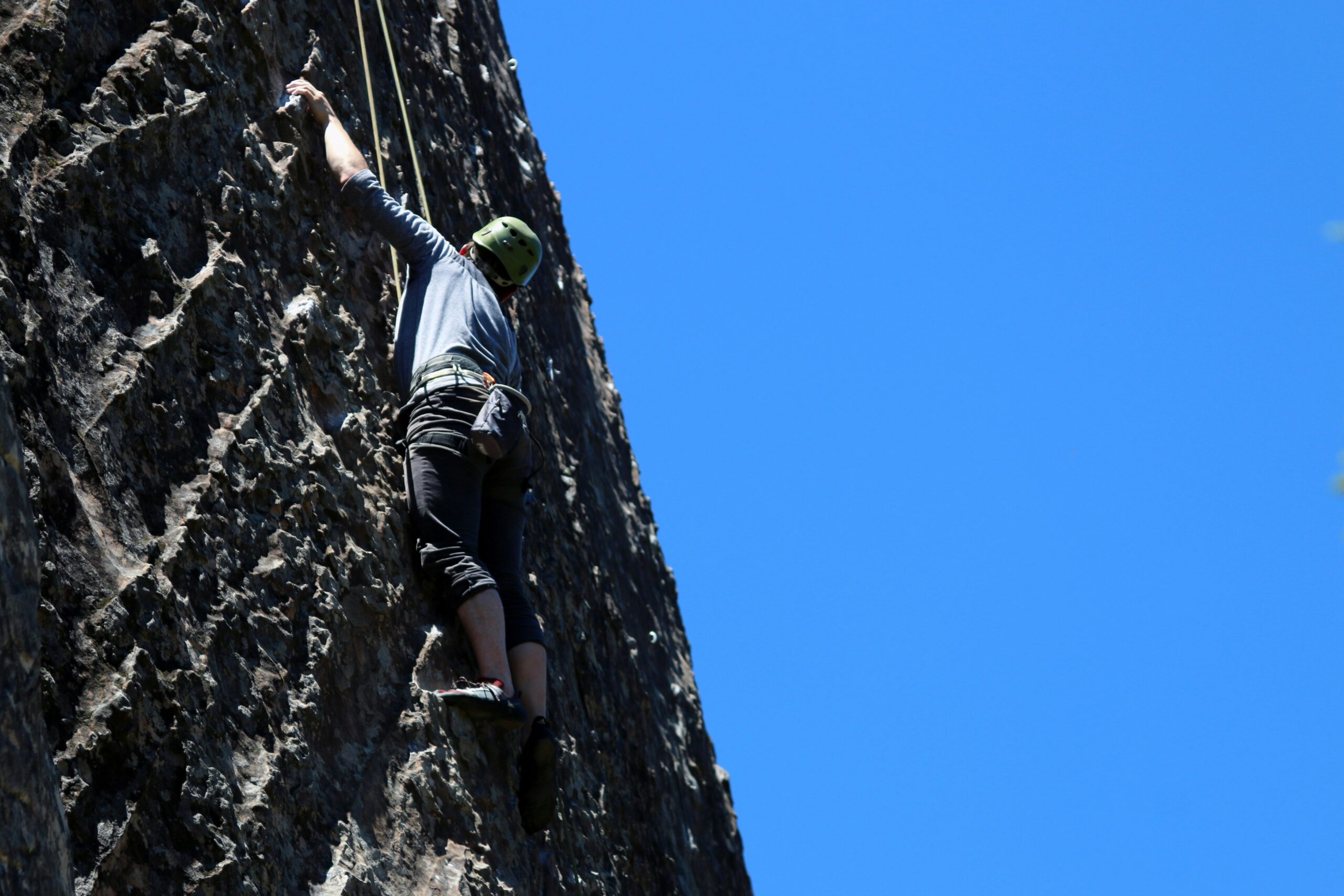 Climber using a belay device with quick-release mechanism