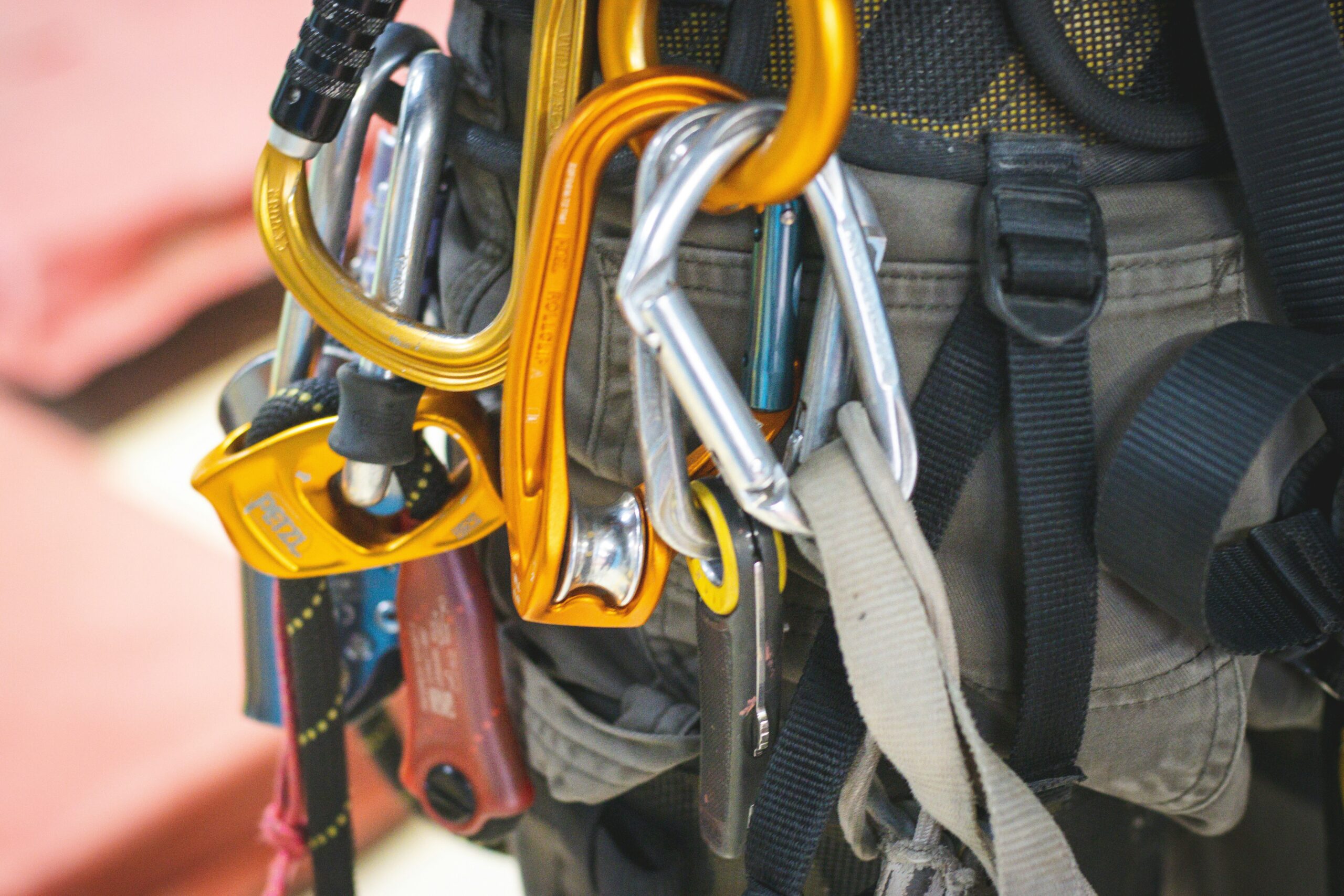 Close-up photo of a climber adjusting belay device settings