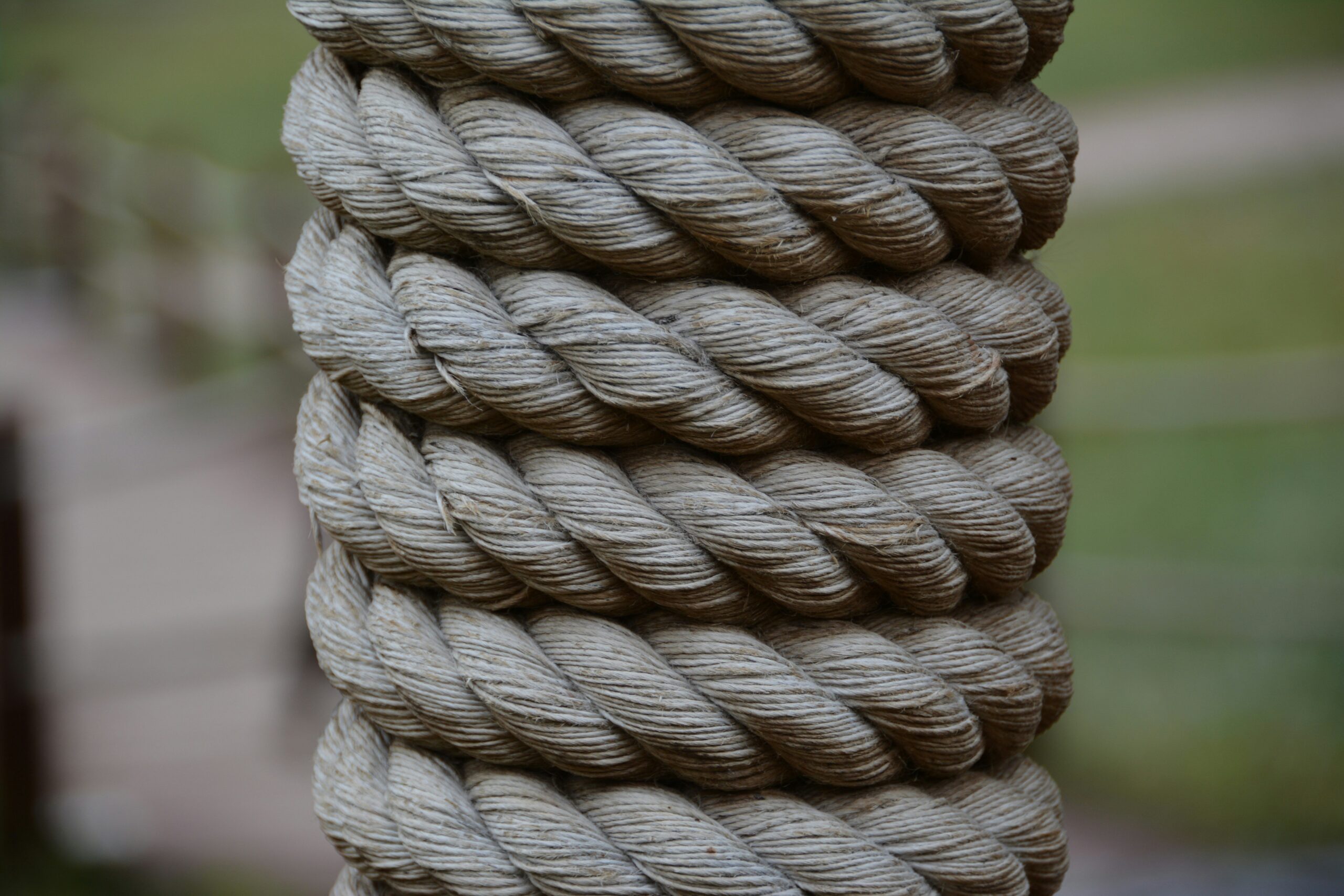 Climber adjusting their rope at an outdoor rock wall