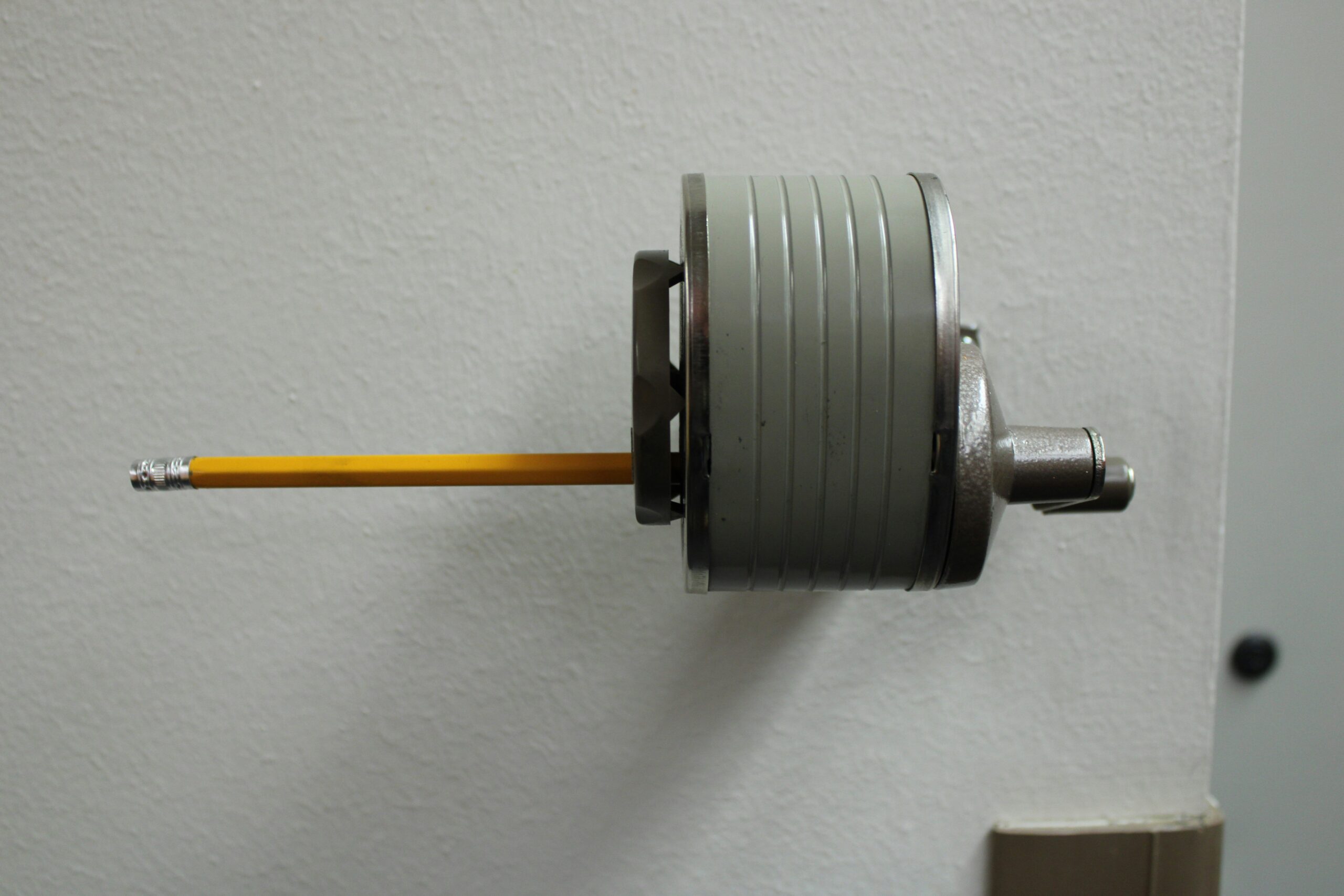 Close-up of cleaning a belay device with a soft brush and mild soap.