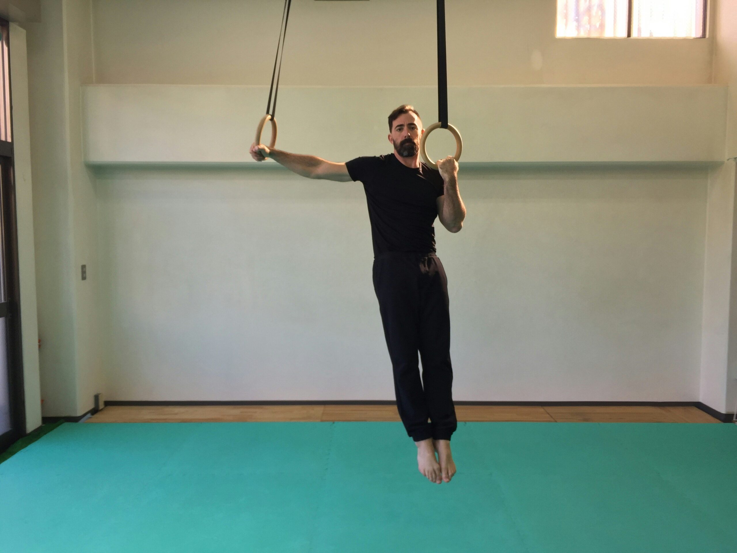 Close-up shot of hands threading a rope through a tubular belay device.